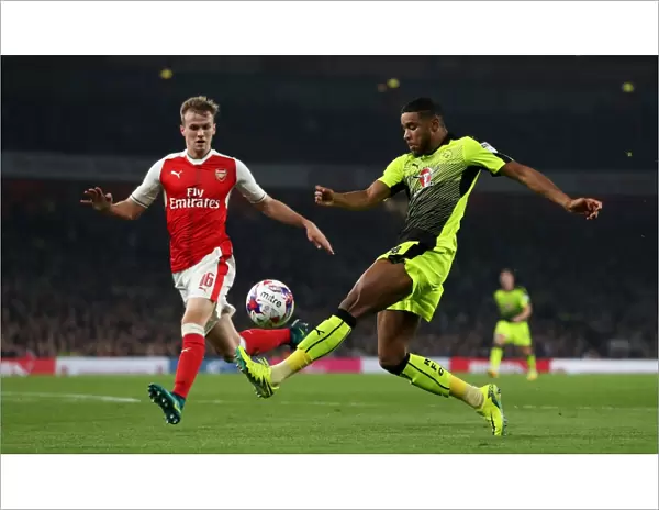 Holding Off Samuel: Intense Battle for the Ball in Arsenal vs. Reading EFL Cup Clash