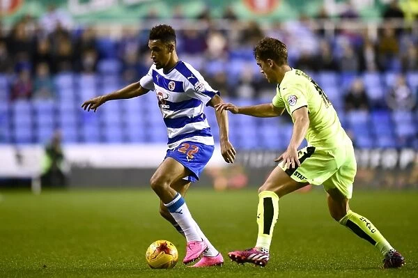 Battle for the Ball: Nick Blackman vs. Emyr Huws in Reading's Championship Showdown with Huddersfield Town