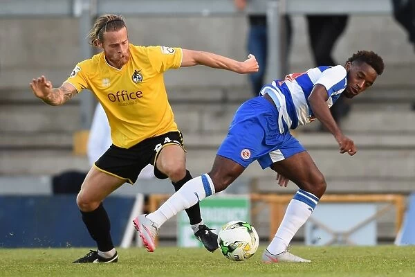 Battle for the Ball: A Riveting Moment between Stuart Sinclair and Tarique Fosu in the Pre-Season Friendly between Bristol Rovers and Reading