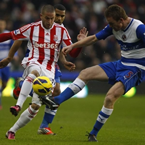 Alex Pearce Outmuscles Michael Kightly: A Battle for the Ball in the Barclays Premier League Clash at Britannia Stadium