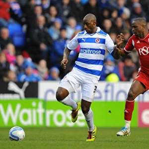 Battle for the Ball: Roberts vs. Cisse in the Intense Npower Championship Clash at Reading's Madejski Stadium