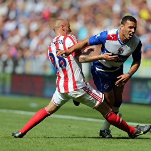Hal Robson-Kanu vs. Andy Wilkinson: Intense Tackle in Reading vs. Stoke City Premier League Clash