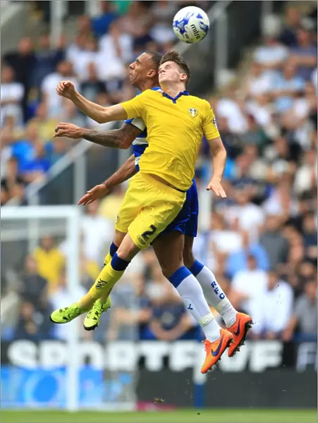 Battle for the Ball: Ferdinand vs. Byram in the Intense Reading vs. Leeds United Championship Showdown at Madejski Stadium