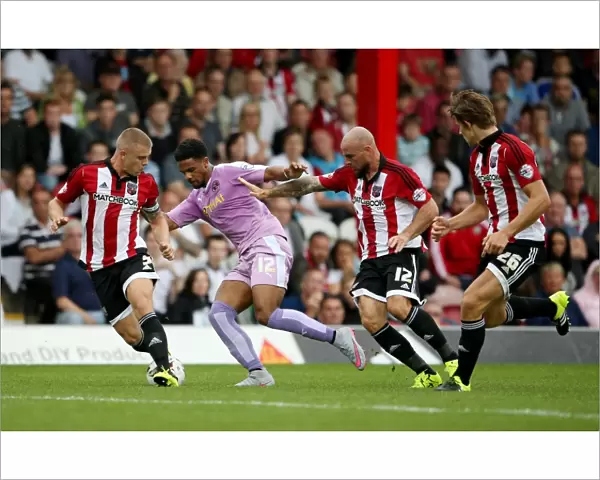 Intense Clash: Gareth McCleary vs. Brentford Defenders at Griffin Park