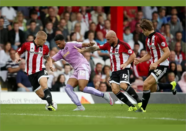 Intense Clash: Gareth McCleary vs. Brentford Defenders at Griffin Park
