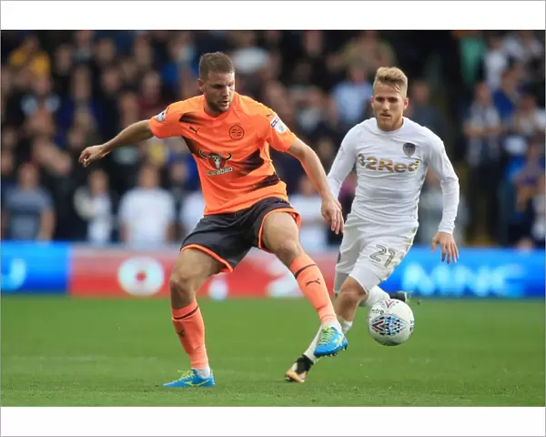Leeds United vs. Reading: Intense Battle for the Ball between Saiz and van den Berg