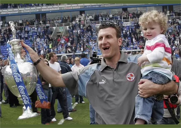 Glen Little celebrates with his son and trophy