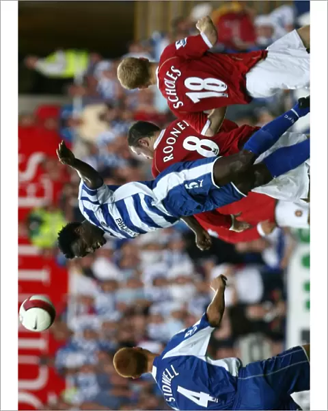 Ibrahima Sonko heads clear of Wayne Rooney & Paul Scholes