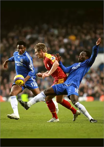 Chelseas Michael Essien and Mikel put the squeeze on Kevin Doyle
