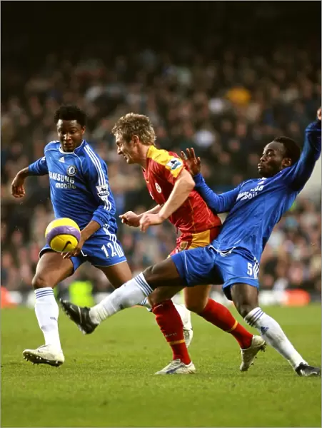 Chelseas Michael Essien and Mikel put the squeeze on Kevin Doyle