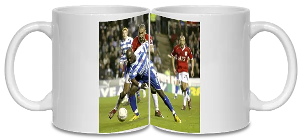 Leroy Lita takes on Rio Ferdinand in the FA Cup 5th round replay at the Madejski