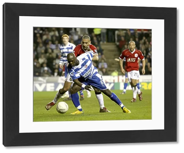 Leroy Lita takes on Rio Ferdinand in the FA Cup 5th round replay at the Madejski