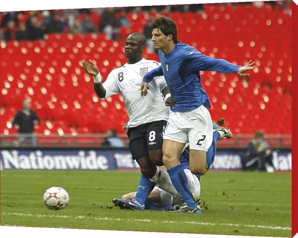Leroy surges through the Italian defence, challenged by defender Marco Andreolli