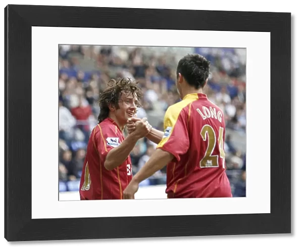 Shane Long goes to congratulate Stephen Hunt on scoring his 92nd minute goal at the Reebok Stadium