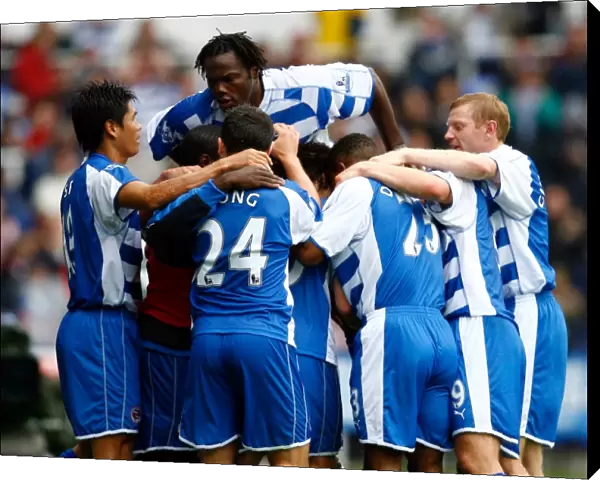 Reading players mob Stephen Hunt after he scores against Everton