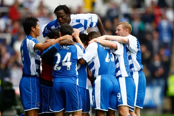 Reading players mob Stephen Hunt after he scores against Everton