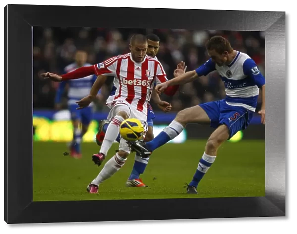 Alex Pearce Outmuscles Michael Kightly: A Battle for the Ball in the Barclays Premier League Clash at Britannia Stadium
