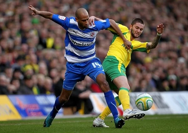 Battle for the Ball: Kebe vs. Lansbury in the Intense Npower Championship Clash at Carrow Road