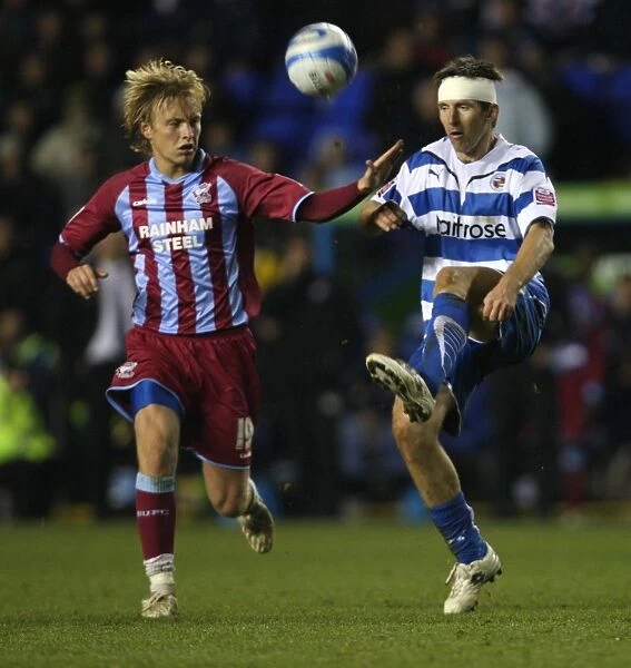 Battle for the Ball: Rasiak vs. Wright in the Intense Championship Clash between Reading and Scunthorpe United at Madjeski Stadium
