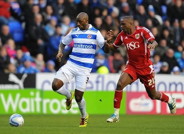 Battle for the Ball: Roberts vs. Cisse in the Intense Npower Championship Clash at Reading's Madejski Stadium
