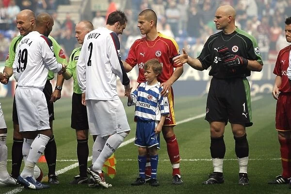 The club Mascot meets the team before the game at Bolton Wanderers