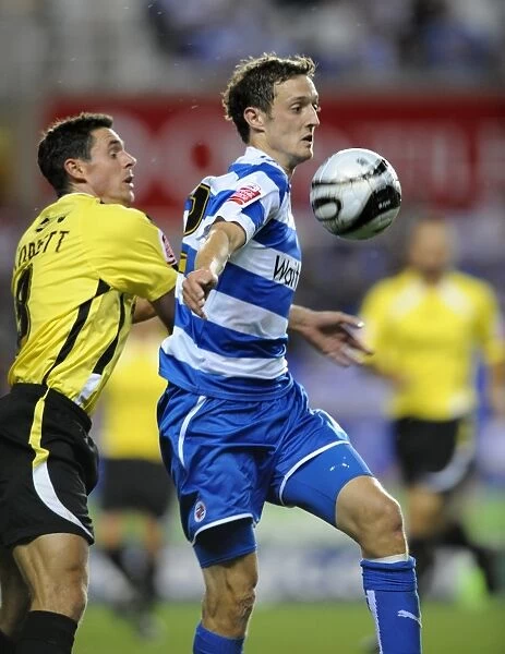 David Mooney vs. Andy Corbett: A Riveting Clash in the Carling Cup between Reading and Burton Albion at Madejski Stadium