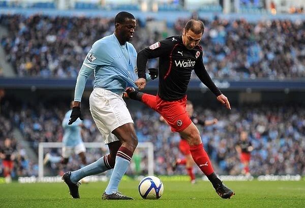 FA Cup Showdown: Yaya Toure vs. Zurab Khizanishvili - A Battle for Manchester City's Ball
