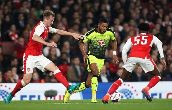 Intense Battle for the Ball: Holding vs. Samuel in Arsenal's EFL Cup Clash
