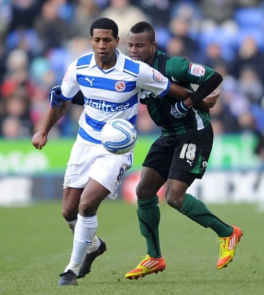 Intense Rivalry: Leigertwood vs. Nimely - A Battle for the Ball in Reading FC's Championship Clash against Coventry City
