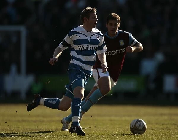 Reading FC vs Aston Villa: Brynjar Gunnarsson Evasive Move Against Stiliyan Petrov in FA Cup Sixth Round at Madejaki Stadium
