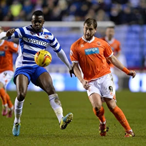 Battle for the Ball: Akpan vs. Davies in the Intense Sky Bet Championship Clash between Reading and Blackpool