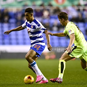 Battle for the Ball: Nick Blackman vs. Emyr Huws in Reading's Championship Showdown with Huddersfield Town