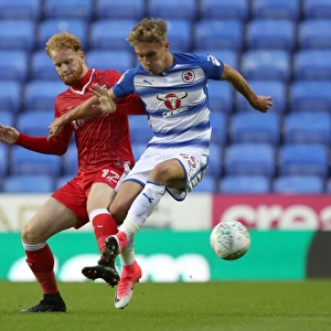Battle for the Ball: Ogilvie vs. Smith in the Carabao Cup First Round Clash at Reading's Madejski Stadium