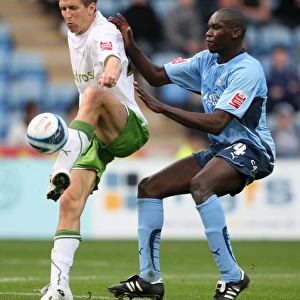 Battle for the Ball: Rasiak vs. Grandison in the Intense Championship Clash between Coventry City and Reading