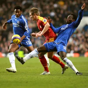 Chelseas Michael Essien and Mikel put the squeeze on Kevin Doyle