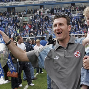 Glen Little celebrates with his son and trophy