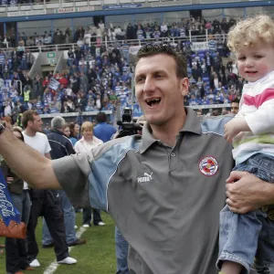 Glen Little celebrates with his son and trophy