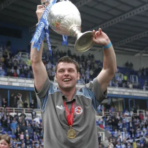 Graeme Murty raises the trophy