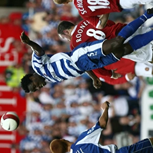 Ibrahima Sonko heads clear of Wayne Rooney & Paul Scholes