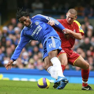 Ivar Ingimarsson stays close to Chelseas top goal scorer Didier Drogba