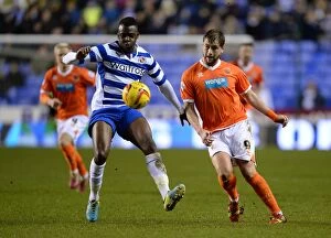 Images Dated 28th January 2014: Battle for the Ball: Akpan vs. Davies in the Intense Sky Bet Championship Clash between Reading