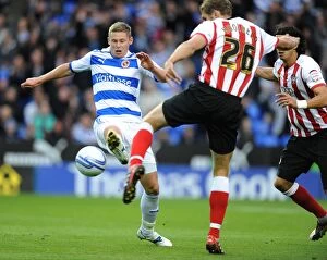 Images Dated 22nd October 2011: Battle for the Ball: Church vs. Hooiveld in the Npower Championship Showdown at Madejski Stadium
