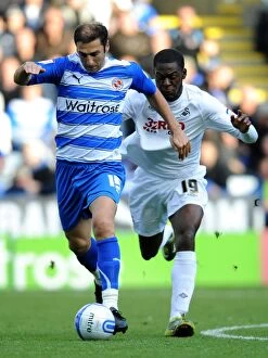 Images Dated 16th October 2010: Battle for the Ball: Khizanishvili vs. Nouble - Reading vs. Swansea City's Intense Rivalry in