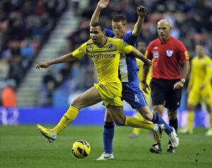 Images Dated 24th November 2012: Battle for the Ball: McCarthy vs. Robson-Kanu - Wigan Athletic vs