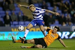 Images Dated 19th April 2016: Battle for the Ball: Rakels vs. Maguire - Intense Championship Showdown at Reading's Madejski