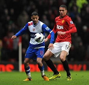 Manchester United v Reading : Old Trafford : 16-03-2013 Collection: Clash at Old Trafford: Smalling vs. McAnuff - A Battle for Ball Supremacy