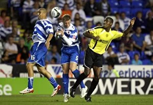Images Dated 11th August 2009: Harper and Mills Go Head-to-Head in Intense Reading vs Burton Albion Carling Cup Clash