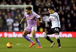 Images Dated 12th January 2016: Intense Rivalry: Tom Ince vs. Danny Williams Battle at iPro Stadium (Sky Bet Championship)