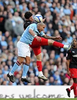 Images Dated 14th March 2011: Nigel De Jong vs. Shane Long: FA Cup Sixth Round Showdown - Heading Battle at Manchester City