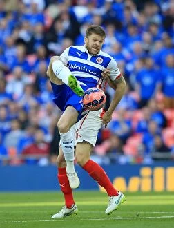 Images Dated 18th April 2015: Reading's Jamie Mackie Defies Arsenal's Laurent Koscielny in FA Cup Semi-Final Aerial Battle at